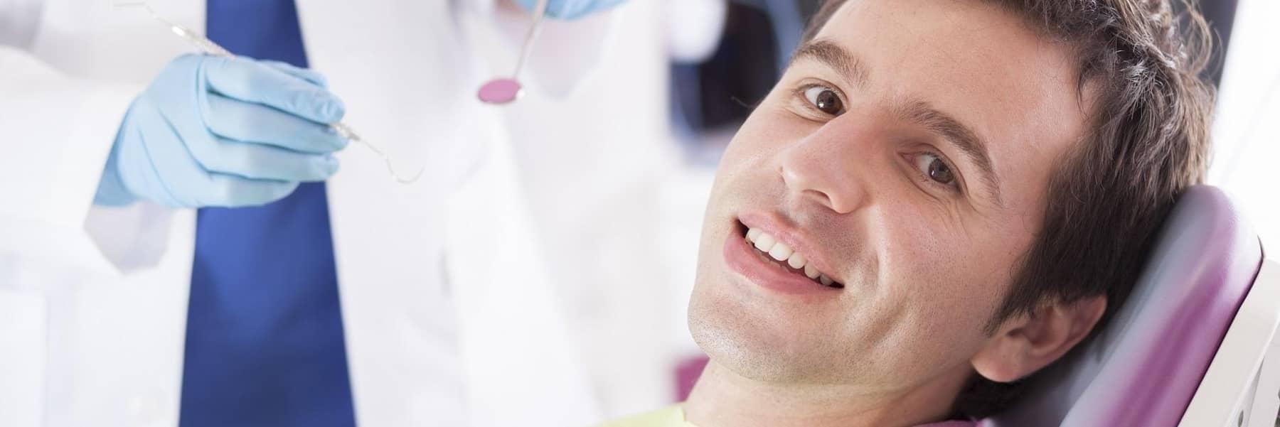 Patient smiling in chair at dentist in Denver CO