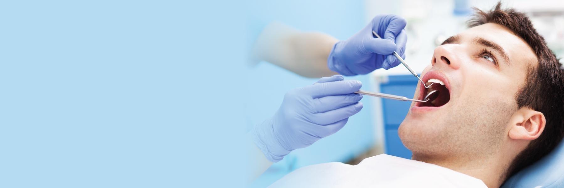 Man receiving periodontal treatment at Denver dentist office